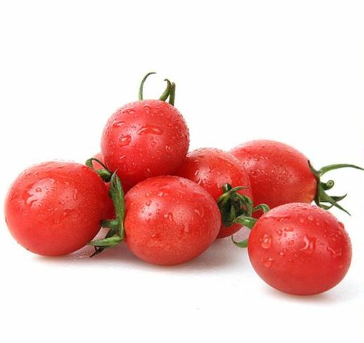 Fresh cherry tomatoes before freezing Fresh red cherry tomatoes with stems on a white background
